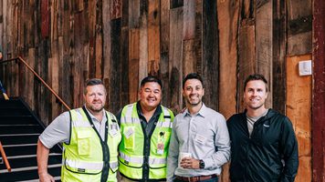 People touring an REI facility, with some wearing personal protective equipment.