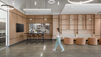The Cancer Diagnostics lobby is a modern office lounge space with wood paneling, sleek furnishings, and an open, airy layout.