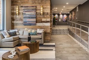 Modern lobby with cozy seating, rustic wood accents, and vibrant wall art decor.