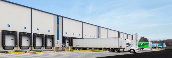 Loading docks at a distribution center with parked semi trucks.