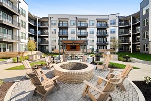 The outside of an apartment building courtyard and fire pit.